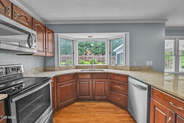 20111 Galen Dr, Abingdon, VA 24211 - kitchen featuring appliances with stainless steel finishes, a sink, ornamental molding, light wood-style flooring, and a textured ceiling