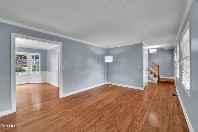20111 Galen Dr, Abingdon, VA 24211 - spare room featuring stairway, a textured ceiling, wood finished floors, ornamental molding, and a wainscoted wall