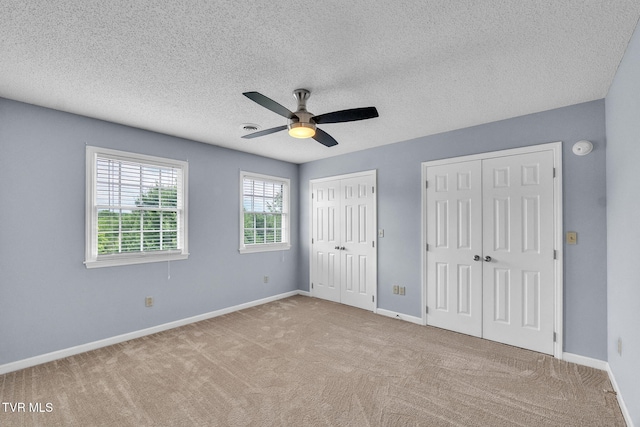 20111 Galen Dr, Abingdon, VA 24211 - unfurnished bedroom featuring two closets, carpet, baseboards, a textured ceiling, and a ceiling fan