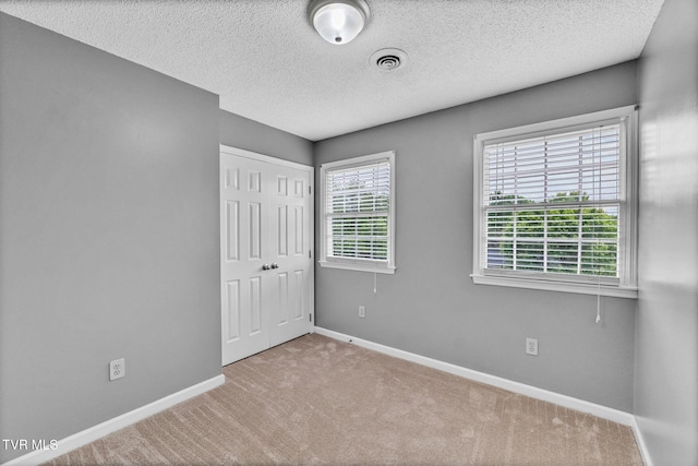 20111 Galen Dr, Abingdon, VA 24211 - unfurnished bedroom featuring baseboards, carpet, a closet, and a textured ceiling