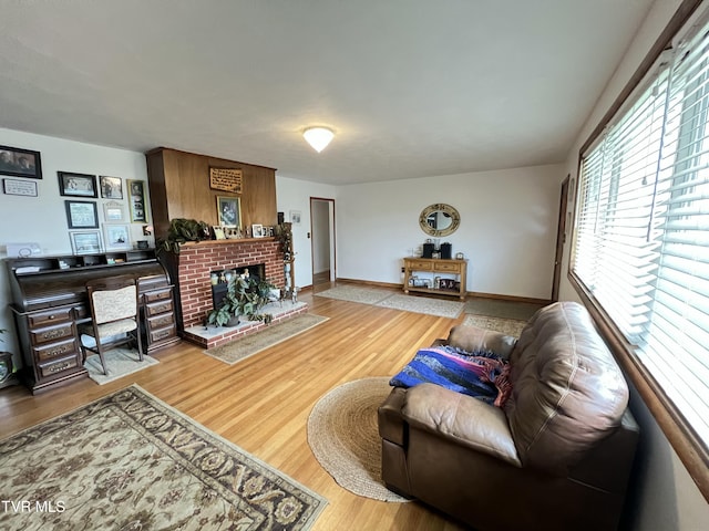 457 Devault St, Church Hill, TN 37642 - living area featuring wood finished floors, a brick fireplace, and baseboards