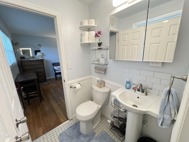 457 Devault St, Church Hill, TN 37642 - bathroom featuring toilet, tile patterned flooring, wainscoting, and tasteful backsplash