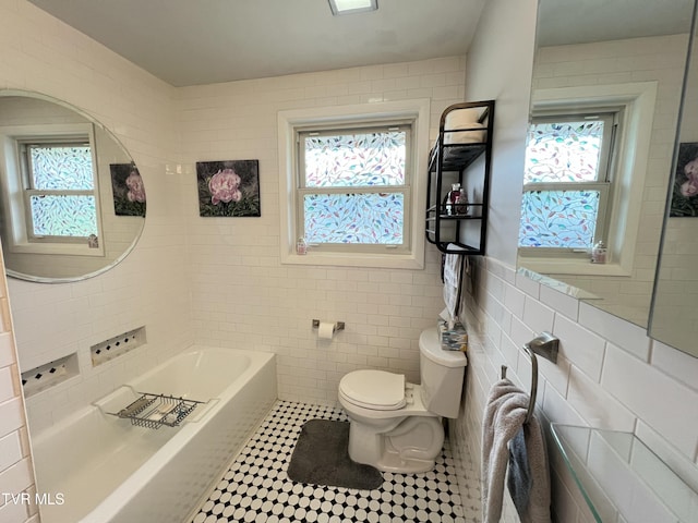 457 Devault St, Church Hill, TN 37642 - full bathroom with tile walls, toilet, plenty of natural light, a bathtub, and tile patterned floors