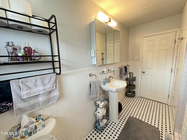457 Devault St, Church Hill, TN 37642 - bathroom with tile walls, toilet, a wainscoted wall, and a sink