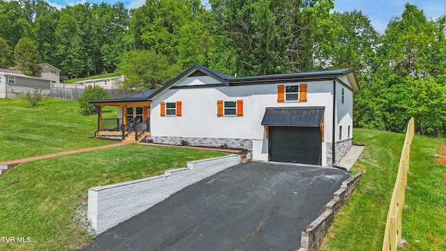 1225 Bristol View Dr, Bristol, VA 24201 - view of front of house with asphalt driveway, a front lawn, a porch, an attached garage, and metal roof