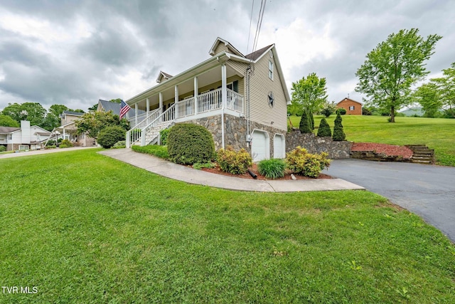 522 Crook St, Hampton, TN 37658 - view of home's exterior featuring stairway, stone siding, asphalt driveway, a yard, and a garage