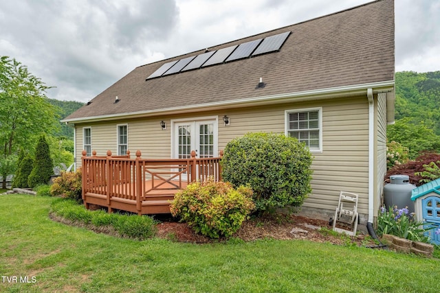 522 Crook St, Hampton, TN 37658 - back of property featuring a lawn, a deck, solar panels, and roof with shingles