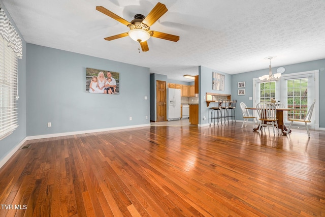 522 Crook St, Hampton, TN 37658 - living area with a chandelier, wood finished floors, a ceiling fan, and baseboards