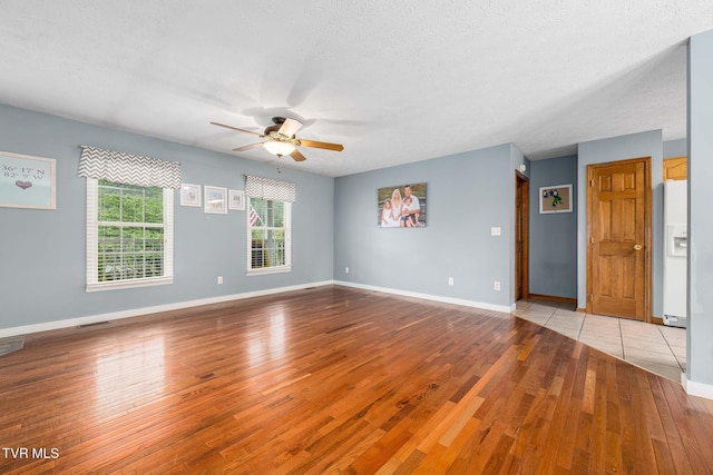 522 Crook St, Hampton, TN 37658 - unfurnished room with light wood-style floors, ceiling fan, baseboards, and a textured ceiling