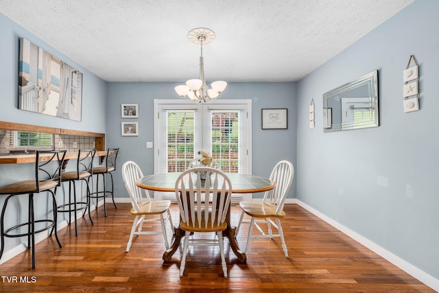 522 Crook St, Hampton, TN 37658 - dining area with wood finished floors, a chandelier, a textured ceiling, and baseboards