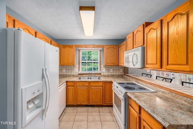 522 Crook St, Hampton, TN 37658 - kitchen featuring white appliances, a sink, decorative backsplash, light tile patterned flooring, and brown cabinetry
