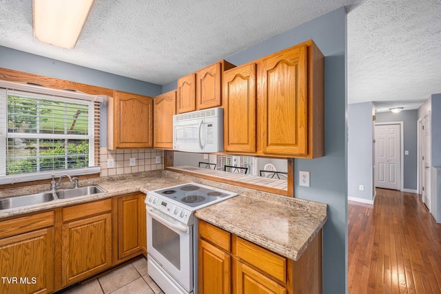 522 Crook St, Hampton, TN 37658 - kitchen featuring white appliances, a sink, a textured ceiling, light countertops, and baseboards