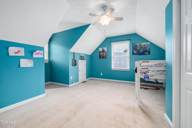 522 Crook St, Hampton, TN 37658 - unfurnished bedroom featuring a textured ceiling, carpet, vaulted ceiling, baseboards, and a ceiling fan