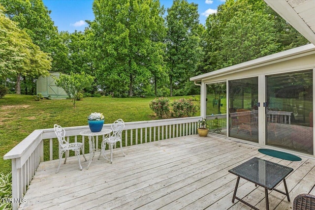 wooden terrace with a lawn and view of scattered trees