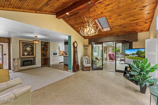living area with healthy amount of natural light, a chandelier, wood ceiling, high vaulted ceiling, and a fireplace