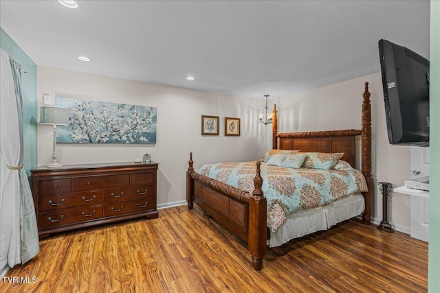 bedroom featuring wood finished floors, baseboards, and recessed lighting