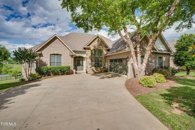 1001 Willows Trace Dr, Johnson City, TN 37601 - french country inspired facade with concrete driveway, brick siding, a garage, and stone siding