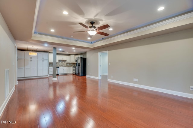 1001 Willows Trace Dr, Johnson City, TN 37601 - unfurnished living room featuring ornamental molding, a raised ceiling, ceiling fan, wood finished floors, and baseboards