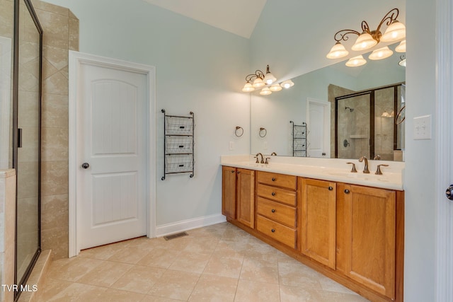 1001 Willows Trace Dr, Johnson City, TN 37601 - bathroom featuring tile patterned flooring, a stall shower, vaulted ceiling, and double vanity