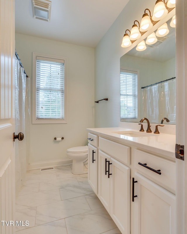 1001 Willows Trace Dr, Johnson City, TN 37601 - bathroom featuring healthy amount of natural light, vanity, toilet, and marble look tile flooring