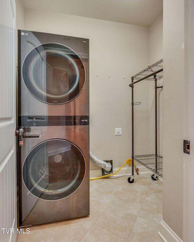 1001 Willows Trace Dr, Johnson City, TN 37601 - laundry room featuring estacked washer and dryer, tile patterned flooring, and baseboards