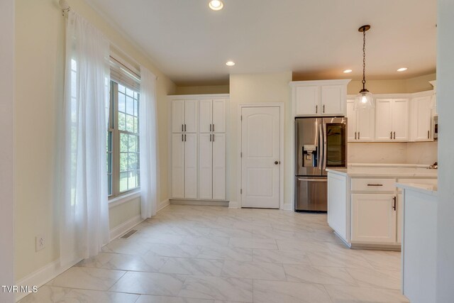 1001 Willows Trace Dr, Johnson City, TN 37601 - kitchen with stainless steel fridge with ice dispenser, light marble finish flooring, baseboards, white cabinetry, and light countertops