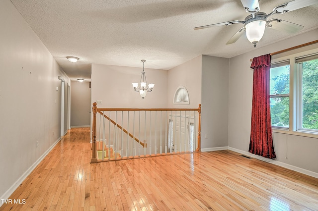 145 Linda Hts, Fall Branch, TN 37656 - spare room featuring hardwood / wood-style flooring, a textured ceiling, a chandelier, plenty of natural light, and a ceiling fan