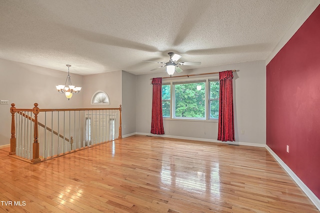 145 Linda Hts, Fall Branch, TN 37656 - empty room with a ceiling fan, light wood-style flooring, a chandelier, a textured ceiling, and baseboards