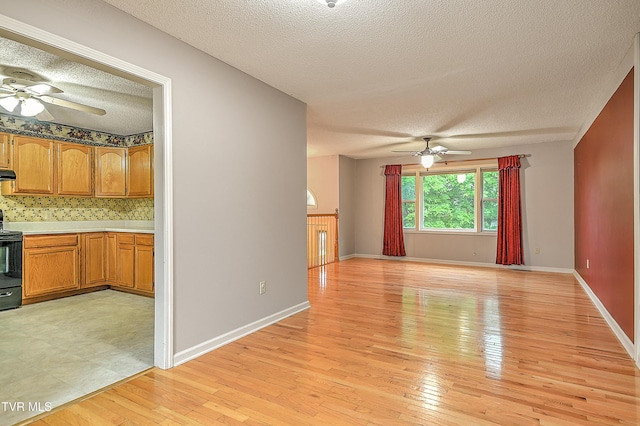 145 Linda Hts, Fall Branch, TN 37656 - unfurnished living room with ceiling fan, a textured ceiling, light wood-style floors, and baseboards