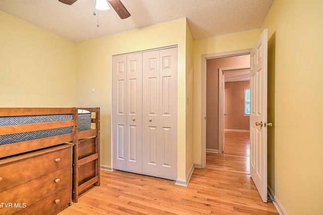 145 Linda Hts, Fall Branch, TN 37656 - bedroom with light wood-type flooring, a closet, baseboards, and a textured ceiling