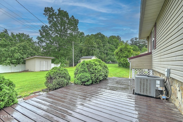145 Linda Hts, Fall Branch, TN 37656 - wooden deck with central air condition unit, a storage unit, a lawn, an outdoor structure, and view of scattered trees