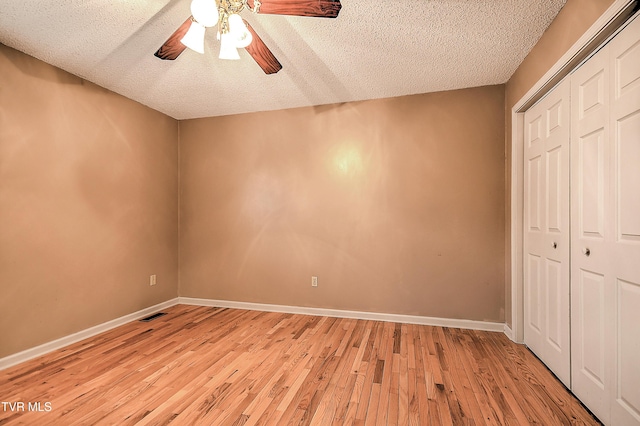 145 Linda Hts, Fall Branch, TN 37656 - unfurnished bedroom featuring light wood-style floors, a textured ceiling, a closet, and baseboards