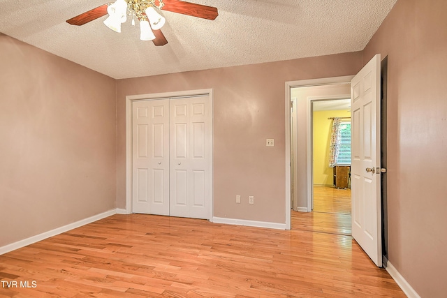 145 Linda Hts, Fall Branch, TN 37656 - unfurnished bedroom featuring light wood-style flooring, a textured ceiling, a closet, and baseboards