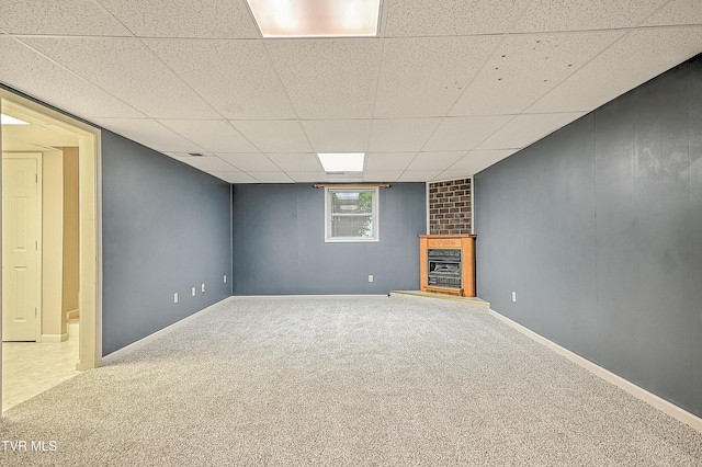 145 Linda Hts, Fall Branch, TN 37656 - below grade area with carpet flooring, a paneled ceiling, a fireplace with raised hearth, and baseboards