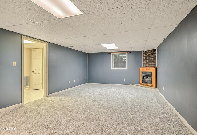 145 Linda Hts, Fall Branch, TN 37656 - basement featuring carpet flooring, a fireplace with raised hearth, baseboards, and a paneled ceiling