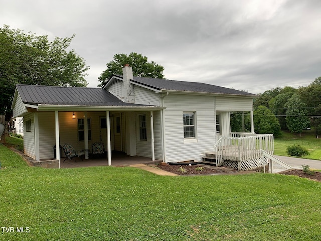 626 N Mohawk Dr, Erwin, TN 37650 - rear view of property with a chimney, a lawn, a patio, and metal roof