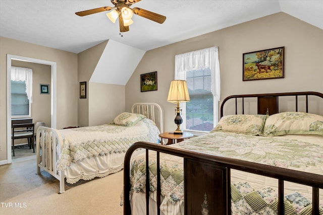 carpeted bedroom with multiple windows, lofted ceiling, a ceiling fan, and baseboards