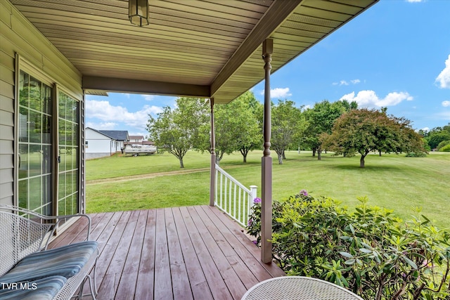 wooden terrace with a lawn