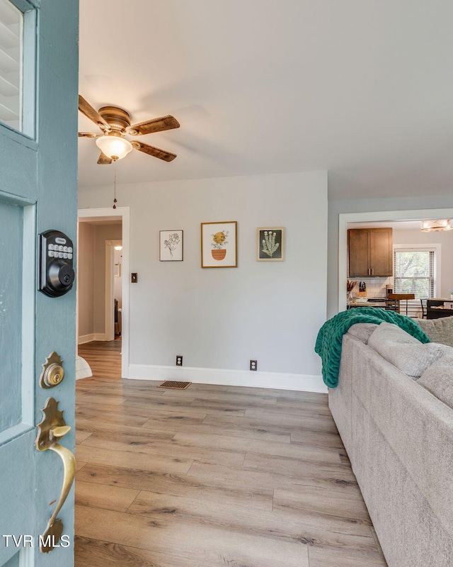 1462 Valley St, Kingsport, TN 37660 - living room with light wood finished floors, a ceiling fan, and baseboards