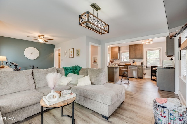 1462 Valley St, Kingsport, TN 37660 - living room with light wood finished floors, ceiling fan, and a chandelier