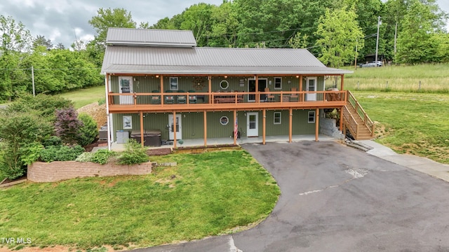 476 Sportsman Dock Rd, Piney Flats, TN 37686 - view of front facade featuring asphalt driveway, a wooden deck, a front lawn, stairs, and metal roof
