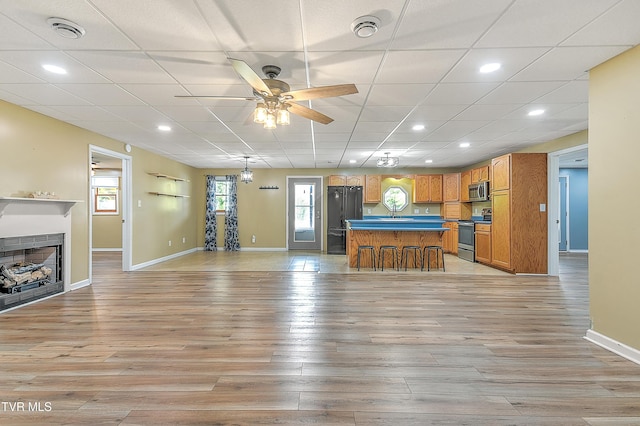 476 Sportsman Dock Rd, Piney Flats, TN 37686 - living room with a ceiling fan, baseboards, light wood finished floors, a fireplace, and recessed lighting