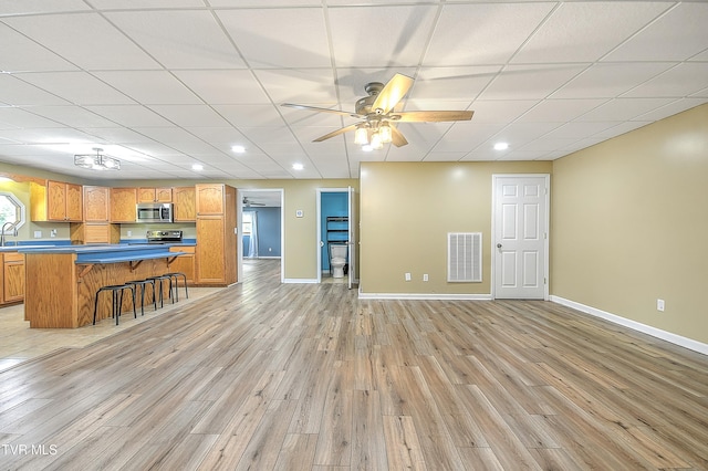 476 Sportsman Dock Rd, Piney Flats, TN 37686 - unfurnished living room with light wood-style floors, baseboards, ceiling fan, a paneled ceiling, and recessed lighting