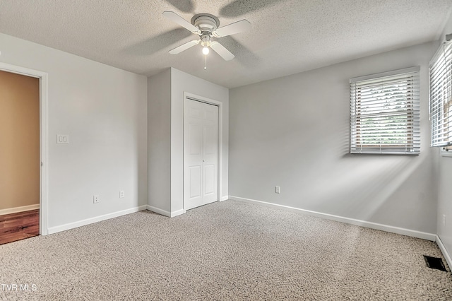 476 Sportsman Dock Rd, Piney Flats, TN 37686 - unfurnished bedroom featuring a textured ceiling, baseboards, a closet, carpet, and ceiling fan
