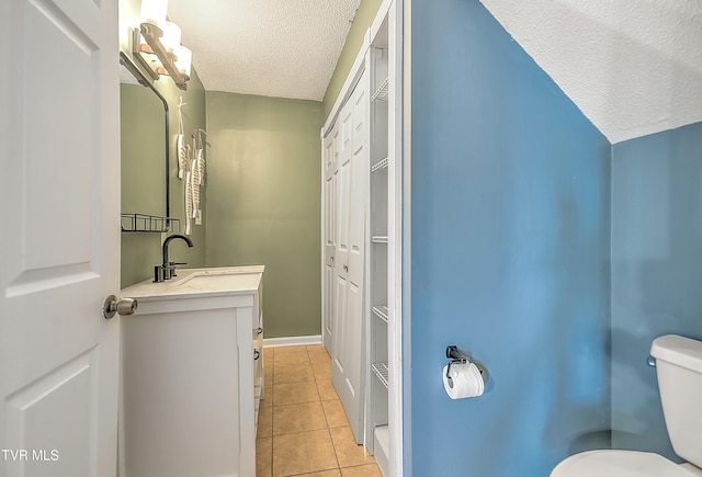 476 Sportsman Dock Rd, Piney Flats, TN 37686 - bathroom with a textured ceiling, tile patterned floors, toilet, vanity, and baseboards