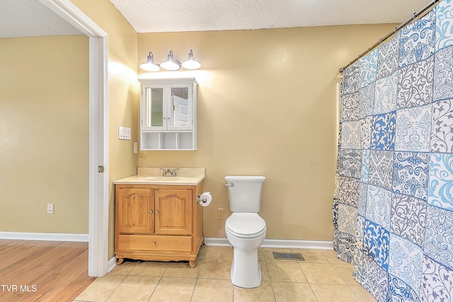 476 Sportsman Dock Rd, Piney Flats, TN 37686 - bathroom featuring toilet, vanity, tile patterned flooring, a textured ceiling, and baseboards