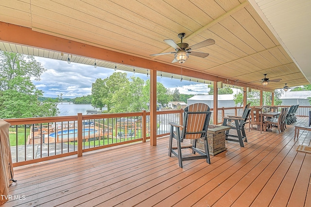 476 Sportsman Dock Rd, Piney Flats, TN 37686 - wooden deck with outdoor dining space, ceiling fan, a community pool, and a storage unit