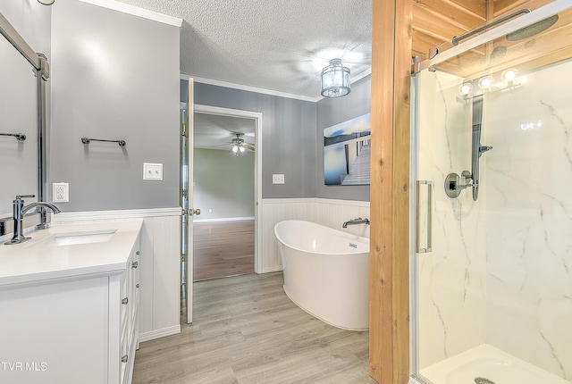 476 Sportsman Dock Rd, Piney Flats, TN 37686 - bathroom with wood finished floors, ceiling fan, a marble finish shower, wainscoting, and a freestanding bath