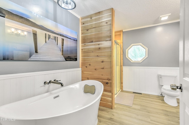 476 Sportsman Dock Rd, Piney Flats, TN 37686 - full bath featuring a wainscoted wall, wood finished floors, toilet, a freestanding bath, and a shower stall
