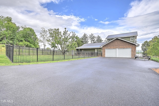 476 Sportsman Dock Rd, Piney Flats, TN 37686 - view of side of property featuring driveway, a garage, fence, and metal roof